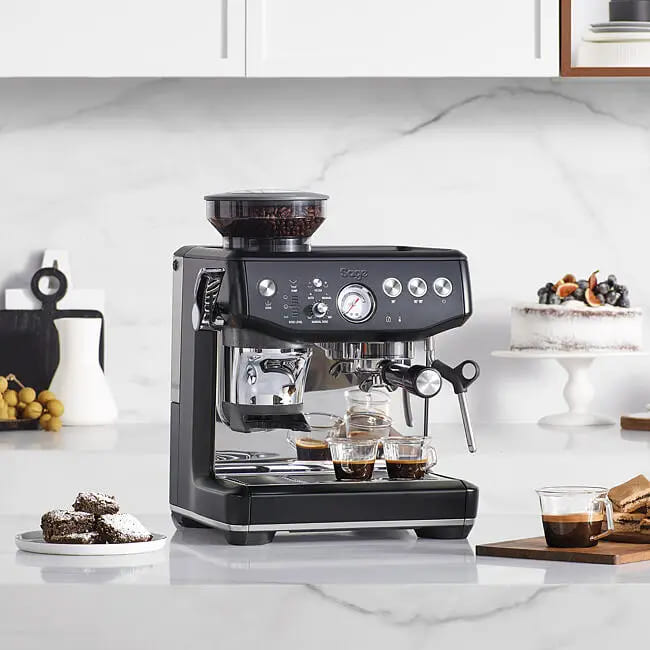 Sage Barista Express Impress Espresso Machine brewing a fresh espresso shot into a coffee cup